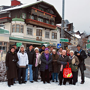 Tour group enjoying a Winter scene in front of Igls hotel